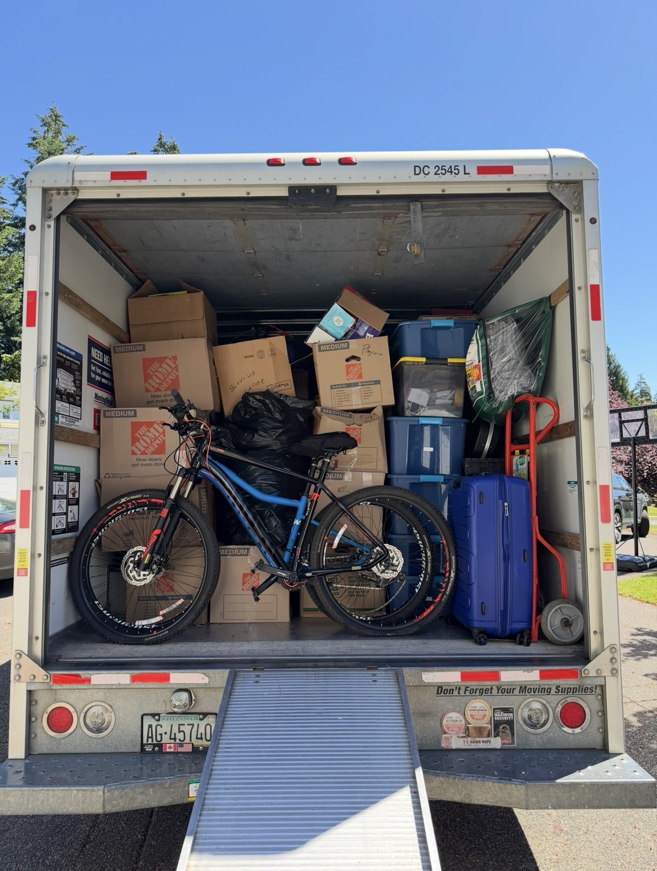 Fully loaded truck with bike, boxes and luggage